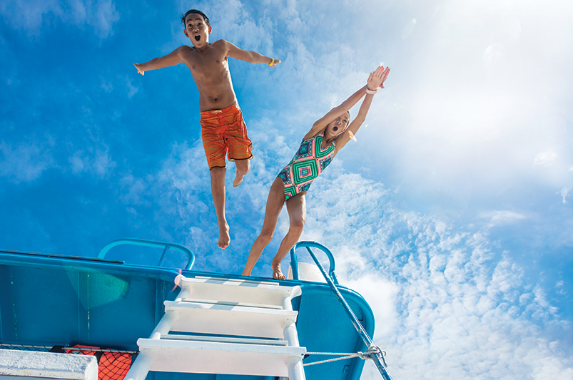 Kids jumping off a pontoon