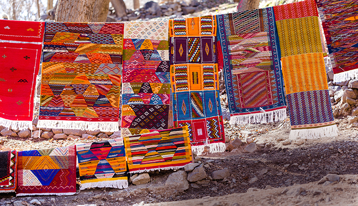 Handmade traditional rugs flutter in the high altitude.