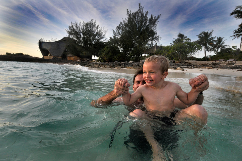 father and son in water, africa