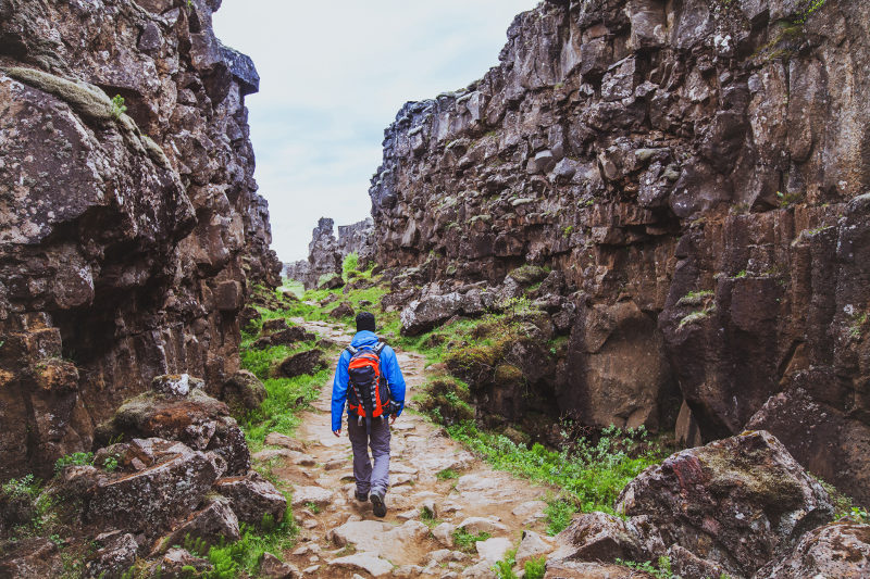 man walking through rocky terrain
