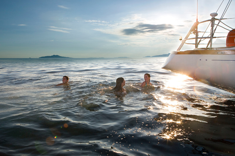 friends in sea near yacht, france