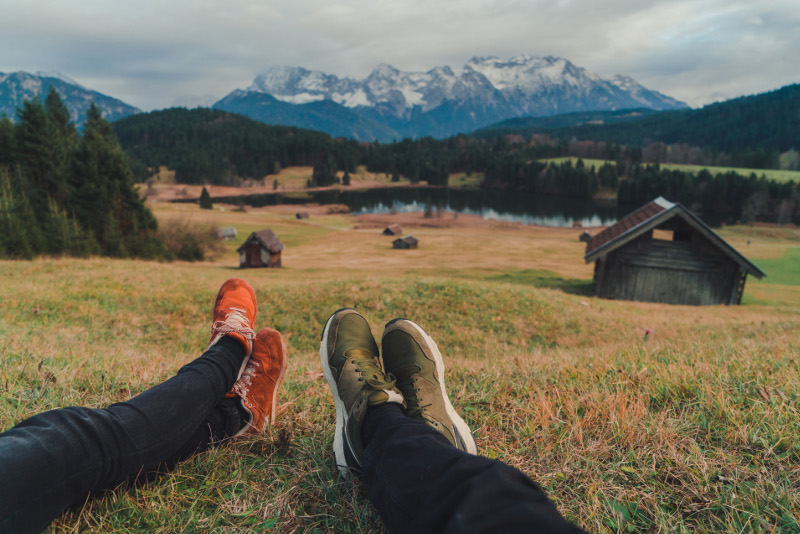 two pairs of legs and scenery lake gerold bavaria germany