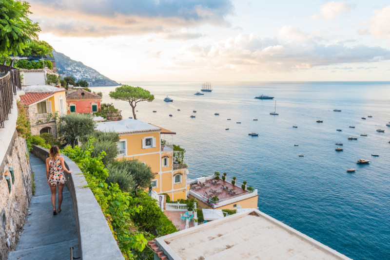 woman walking along coast path in italy