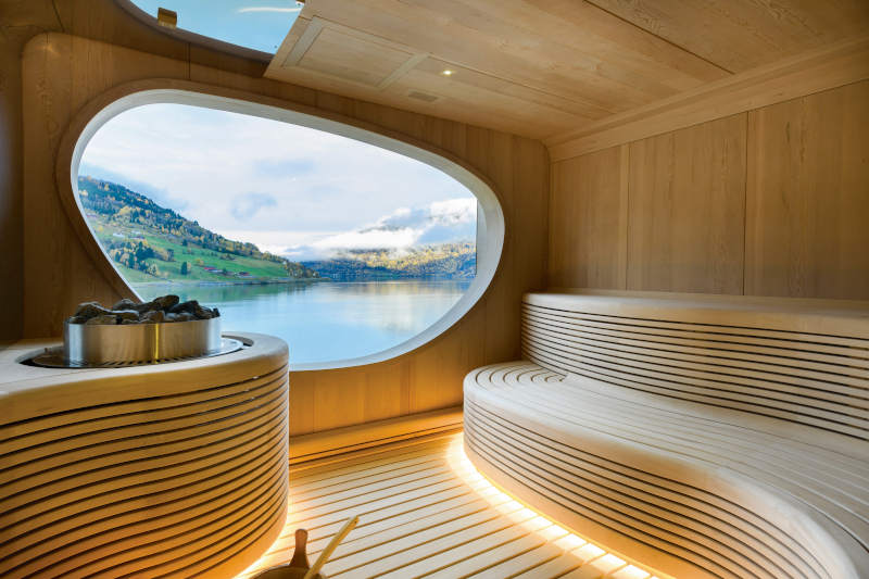 Wooden sauna interior of the spa, a view of an island out the window