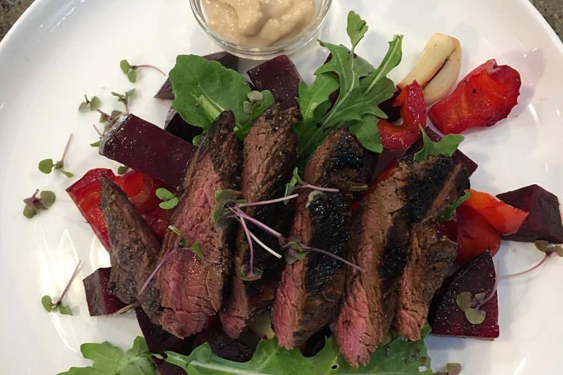 A plate of steak and salad