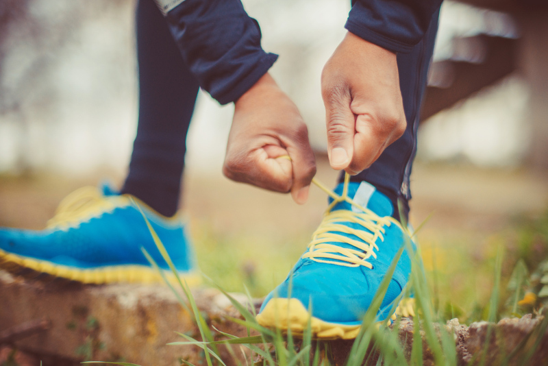 A person putting their running shoes on