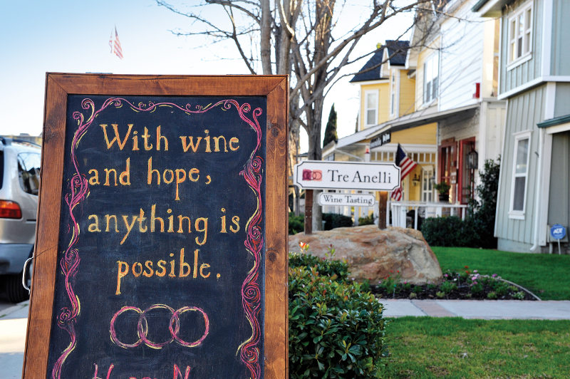 A sign outside a wine-tasting place in Santa Barbara reads: With wine and hope, anything is possible.