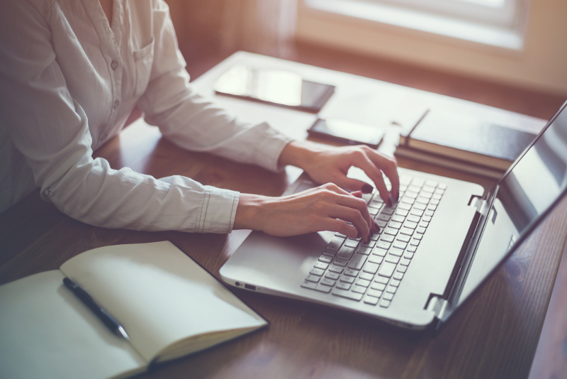 A professional person working on a laptop