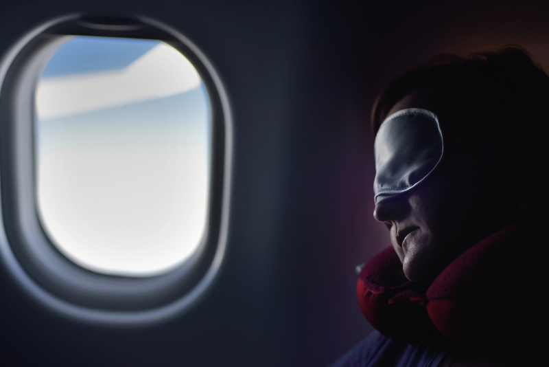 A person sleeping on a plane
