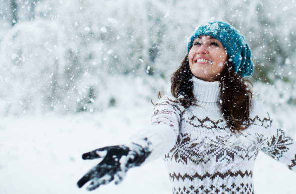 A young woman watching the snow fall