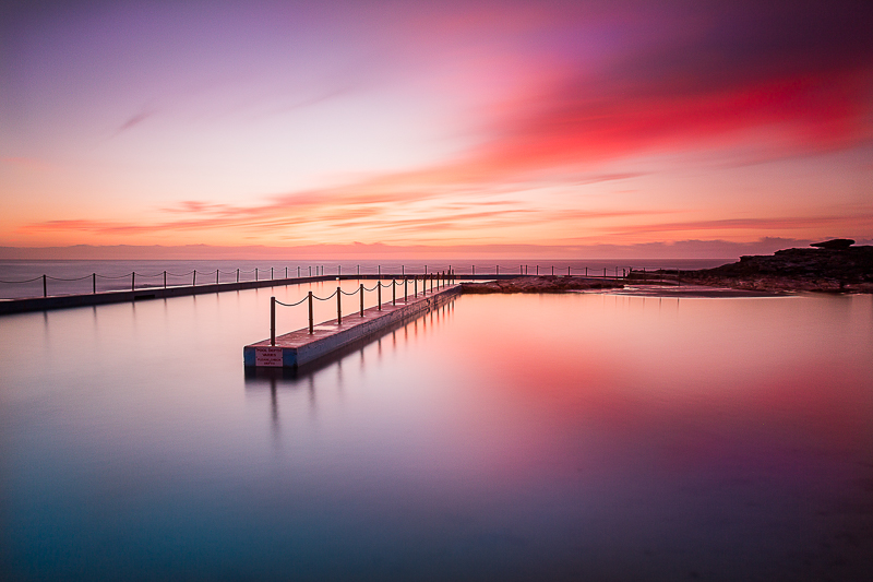 smooth water on rock pool surface at sunrise