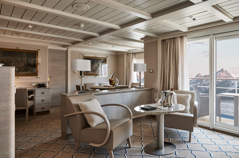 suite onboard silver cloud with snow-capped mountains behind