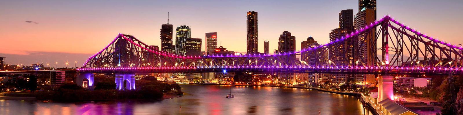 Brisbane's skyline, featuring the Story Bridge, at twilight.