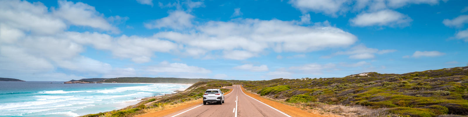 car driving along side beach