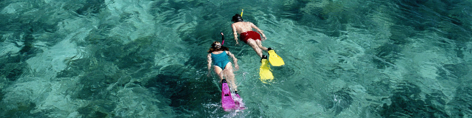 two snorkellers from above in ocean