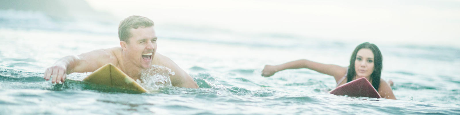 couple on surfboards hawaii