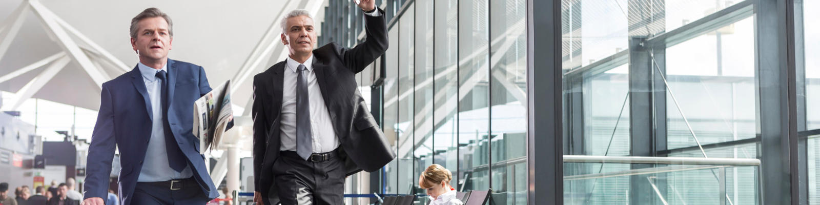 Two men running for their flight through the airport