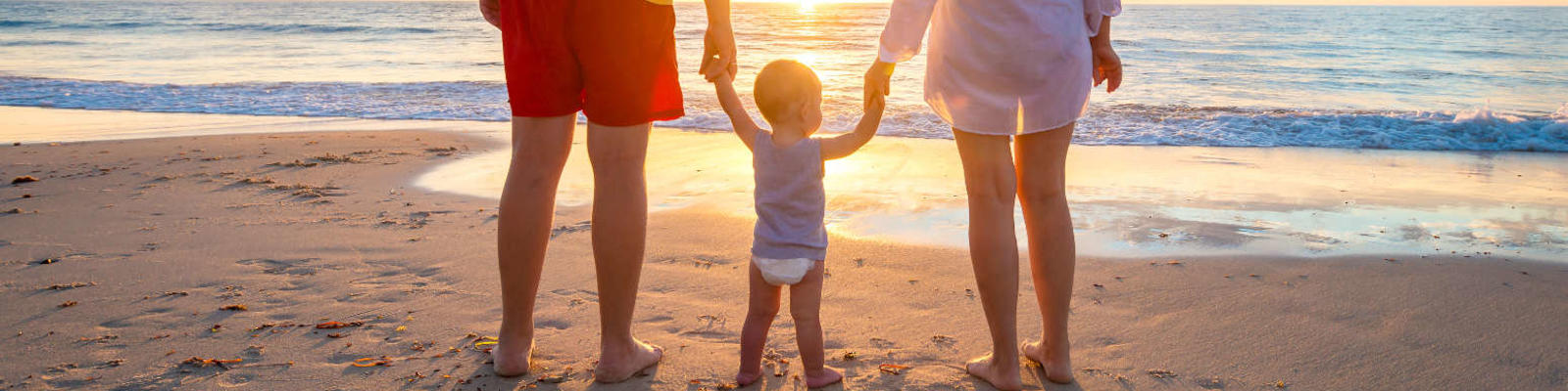 family on beach at sunset