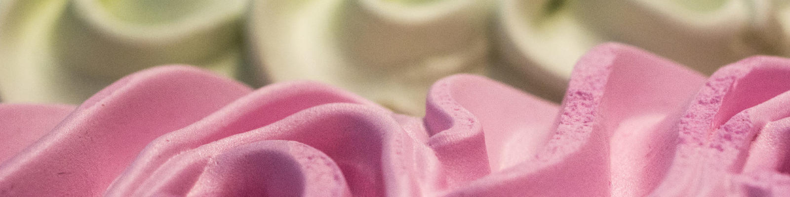 A close up of vanilla and strawberry ice cream
