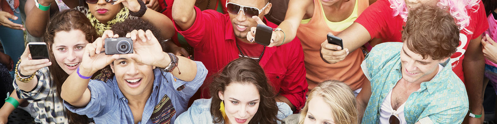 A crowd of audience members at an outside TV show taping.