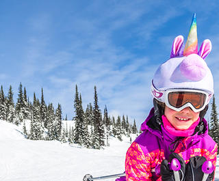 girl skiing on the slopes at Big White Cananda, dressed as a unicorn. Credit: Big White Ski Resort