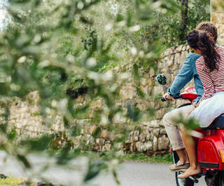 couple on moped in italian countryside