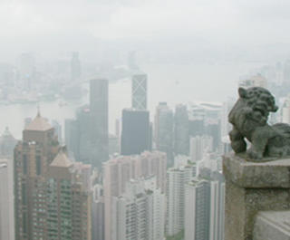 A male and female look at the view from Hong Kong's The Peak.