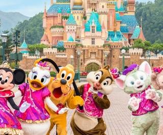 Disney characters at Hong Kong Disneyland in front of the Castle of Magical Dreams