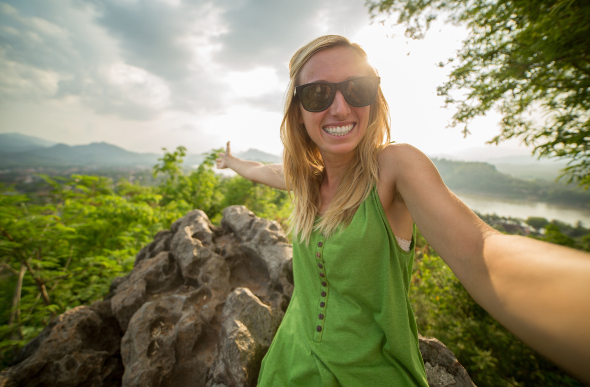 A girl taking a selfie wearing sunglasses