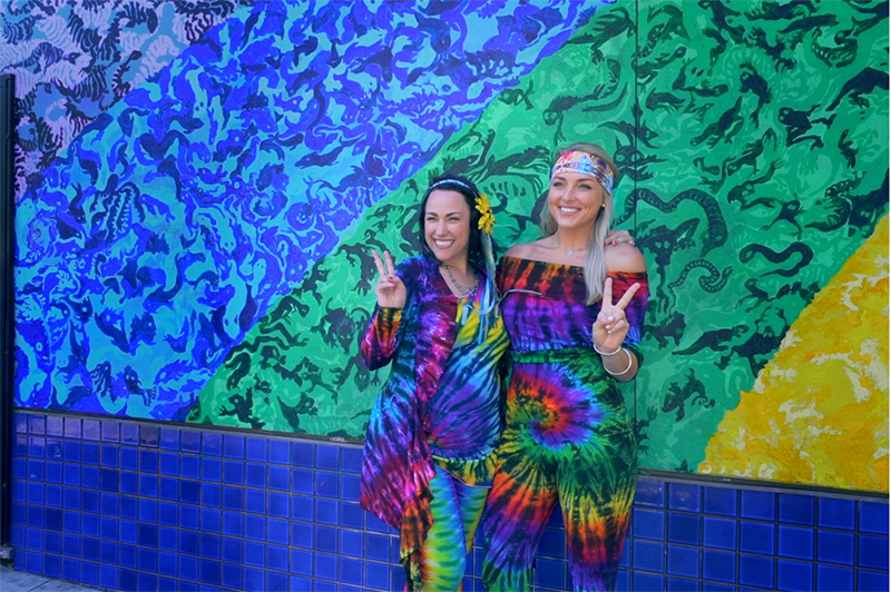 Two women in 1960s tie-dye clothing.
