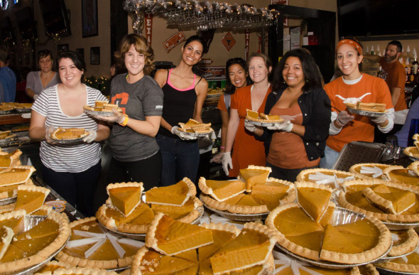 A group of volunteers serving pumpkin pie