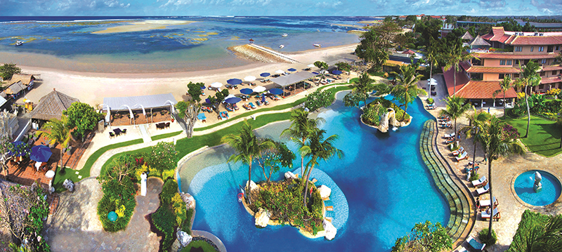 An aerial view of the resort including pool, beach and resort block