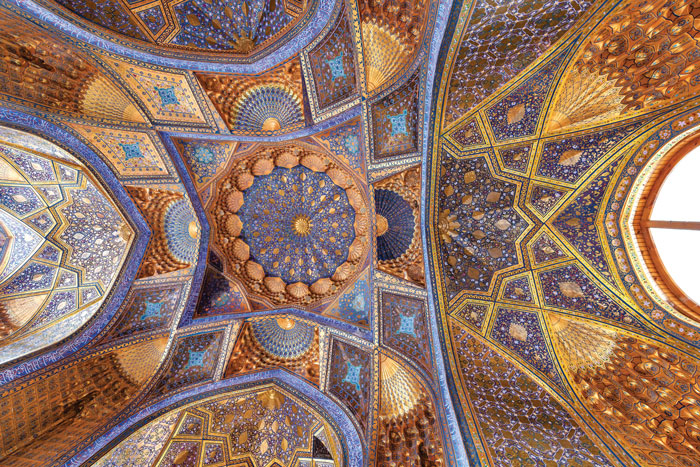 image of the ceiling of intricate detail of the colourful blue and gold ceiling of the Tilya Kori Madrassa in Samarkand