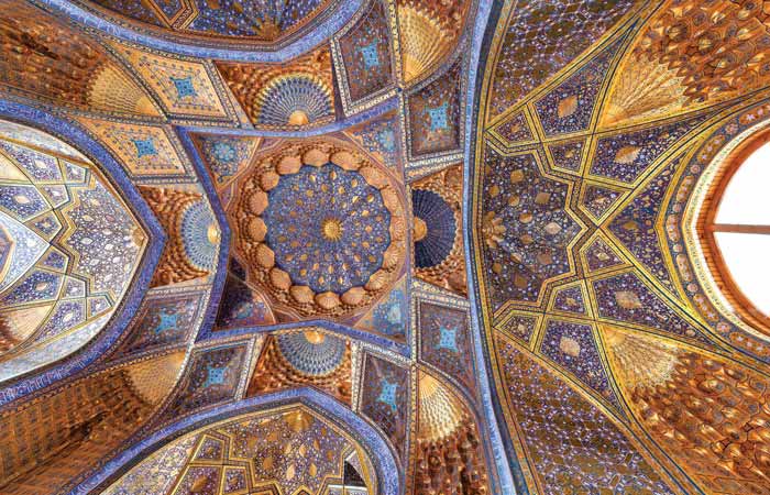 image of the ceiling of intricate detail of the colourful blue and gold ceiling of the Tilya Kori Madrassa in Samarkand