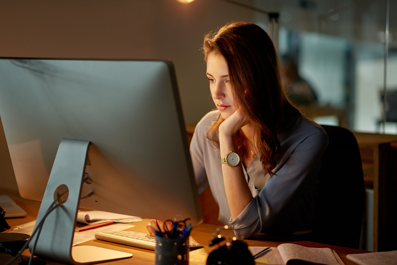 A woman looking at her computer