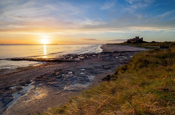 sunrise on bamburgh beach uk