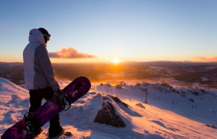Snow boarder watching Sunrise in Blue Cow, Perisher Snowy Mountains.