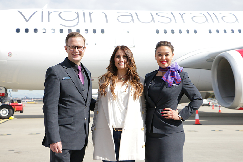 Virgin Australia staff pose in front of plane