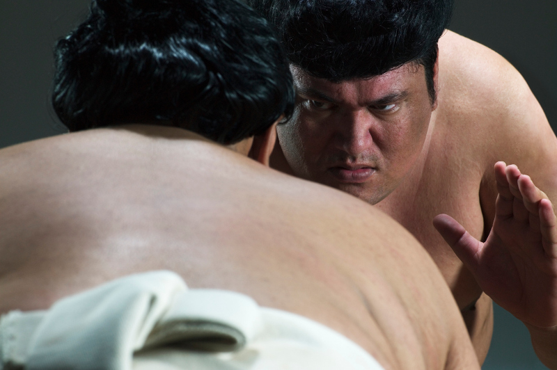 A close-up of sumo wrestlers.