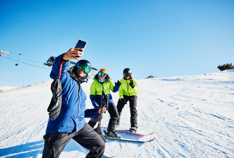 Snowboarding mates snap a selfie on the slopes.