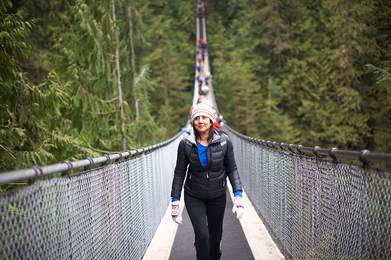 A woman walks on the Capilano Suspension Bridge in Vancouver, Canada.