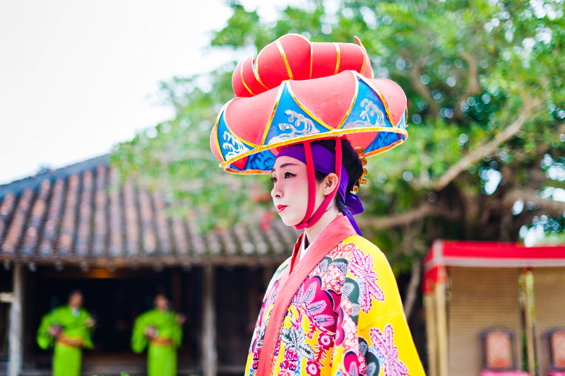 A woman in tradtiional dress in tropical Okinawa, Japan.