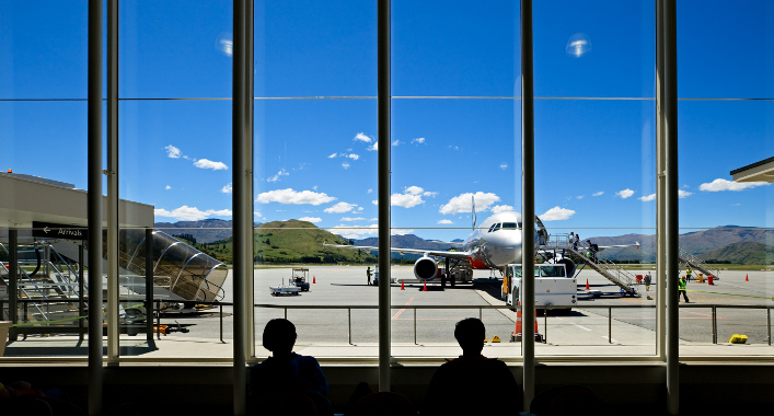 Travellers at Queenstown Airport, New Zealand, waiting to board a flight